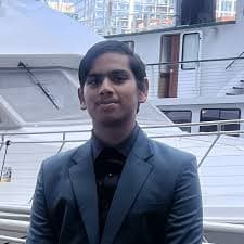 Portrait of Tanay Mangal wearing a suit